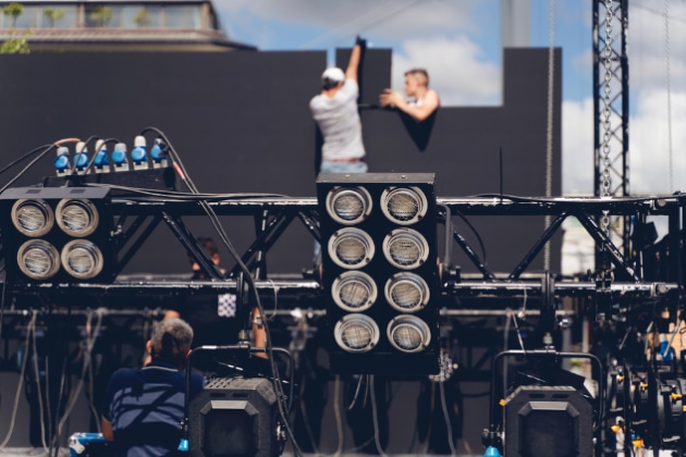 lighting and Led panel technician iinstalling professional lighting equipment for concert stage , installation with led lights, led panel and projectors